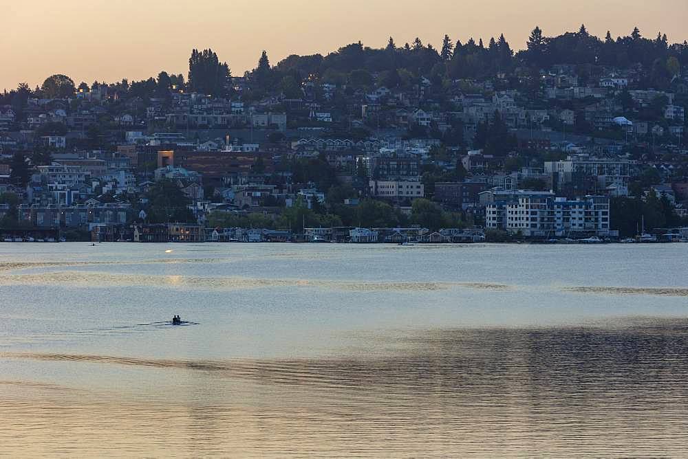 Crew racers rowing double scull boat on Lake Union at dawn, Seattle, Washington, United States of America