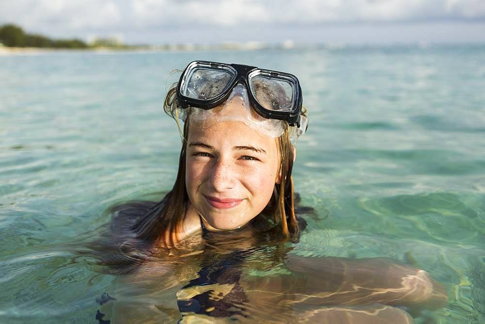 A teenage girl wearing snorkelling mask in the ocean, Grand Cayman, Cayman Islands