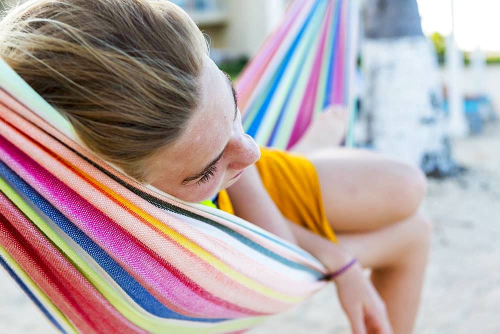 A teenage girl resting in hammock, Grand Cayman, Cayman Islands