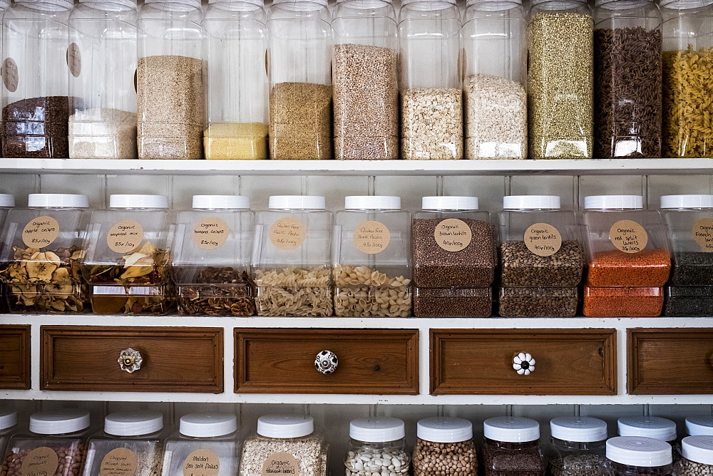 Close up of shelves with a selection of pasta, legumes and grains in glass jars