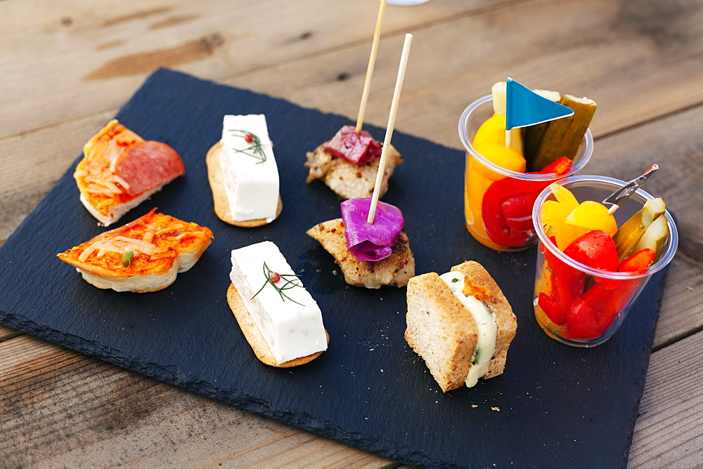 High angle close up of a selection of sandwiches and fresh vegetables on slate tray, Kyushu, Japan