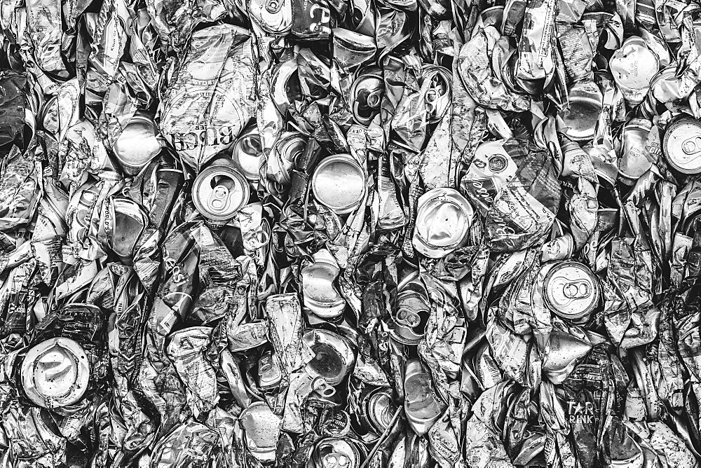 Mass of aluminium cans being processed at a recycling plant, Recycling facility, California, USA