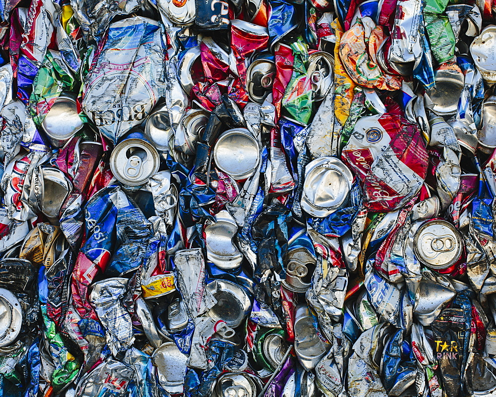 Mass of aluminium cans being processed at a recycling plant, Recycling facility, California, USA