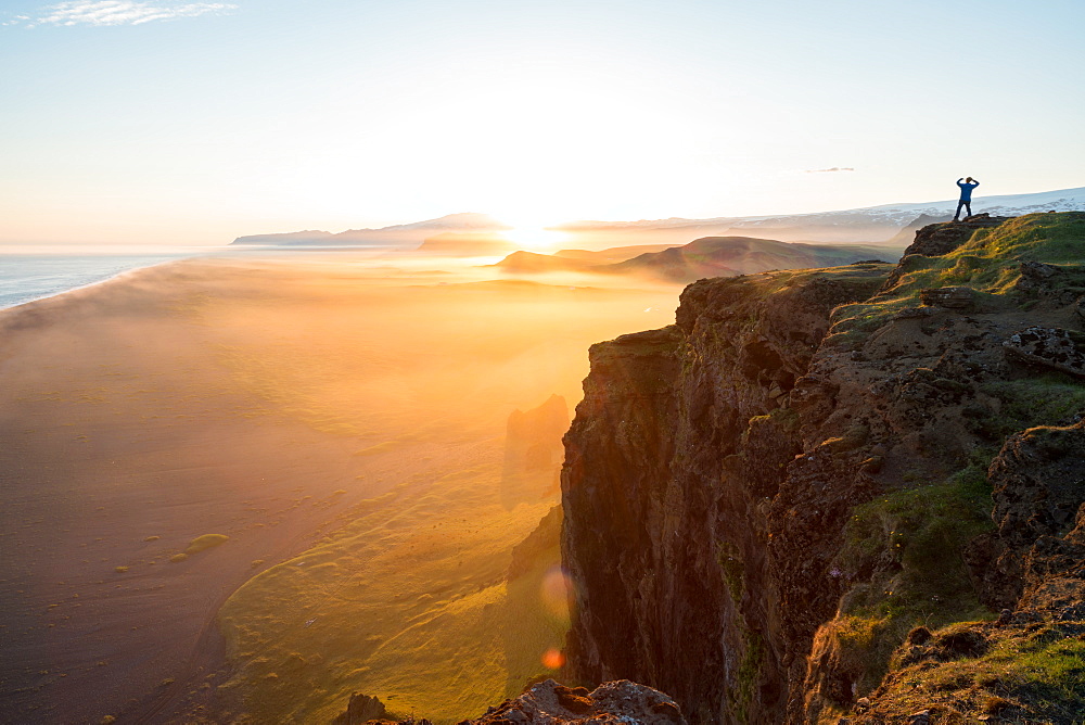 Man looking at the view at sunset from Dyrholaey Peninsula, near Vik, South Iceland (Sudurland), Iceland, Polar Regions, Iceland