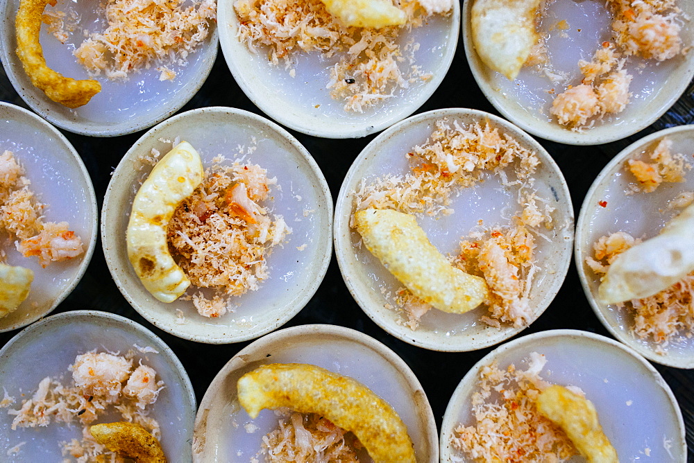 High angle close up of Banh beo, or sticky rice with dried shrimp and pork crackling, Vietnam