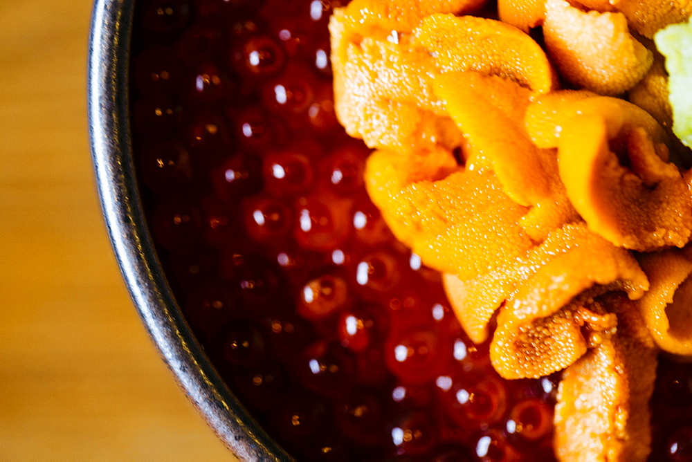 High angle close up of uni, sea urchin, with salmon roe and rice, Japan