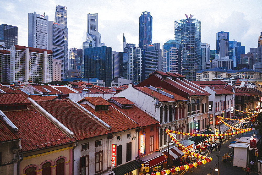 High angle view of old shophouses of Chinatown and the modern skyscrapers of Singapore at dusk, Singapore