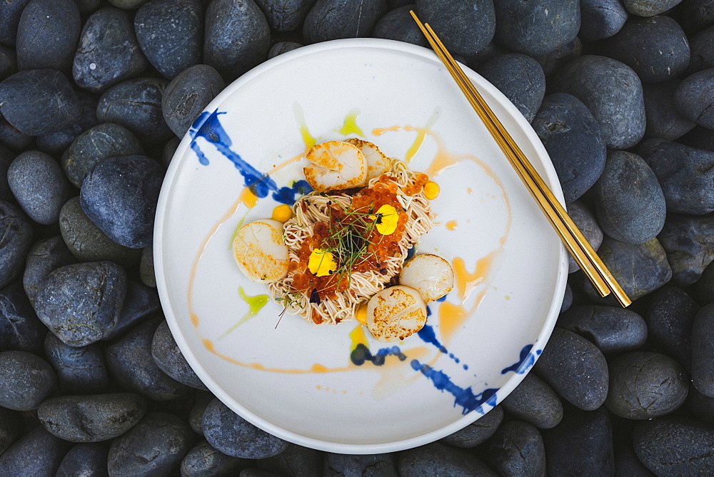 High angle close up of scallop somen with fish roe, ebi, and salted egg yolk sauce, Singapore