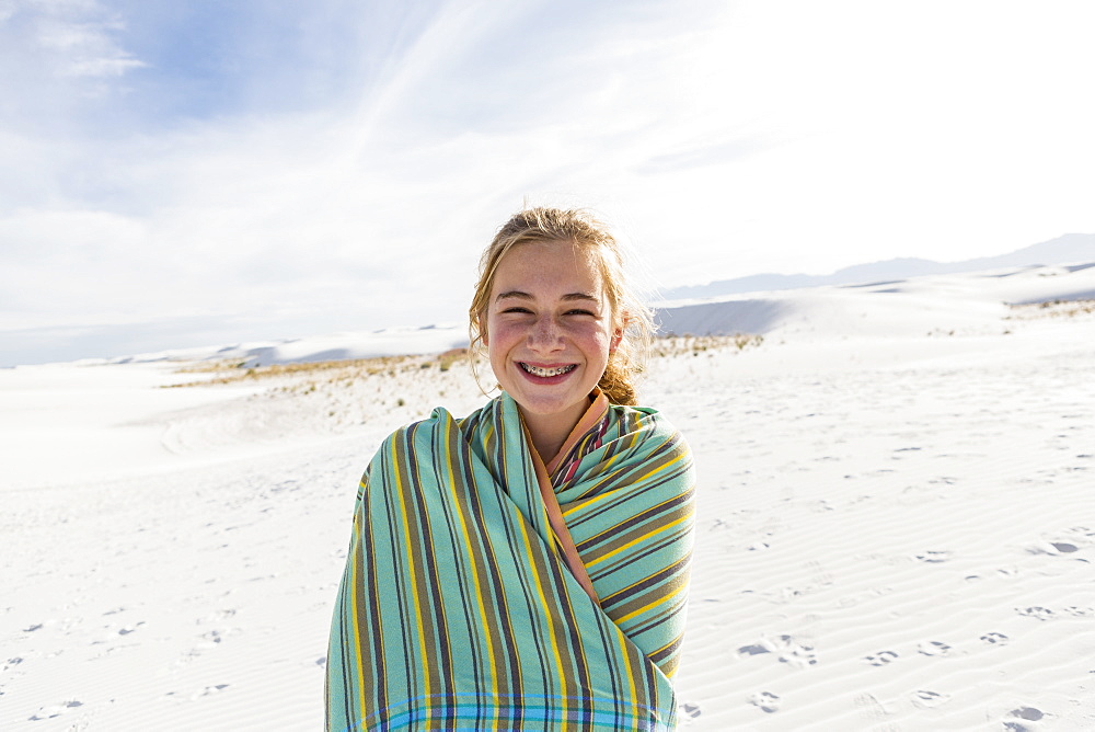 Teenage girl in a towel on the sand, White Sands National Monument, New Mexico, United States