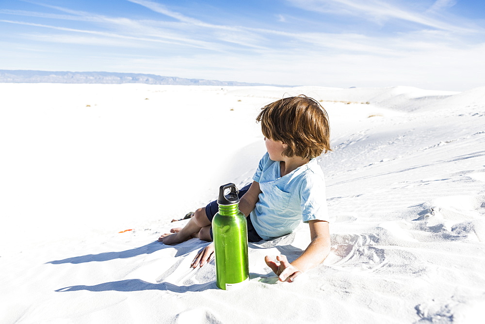 A young boy with green water bottle, White Sands National Monument, New Mexico, United States