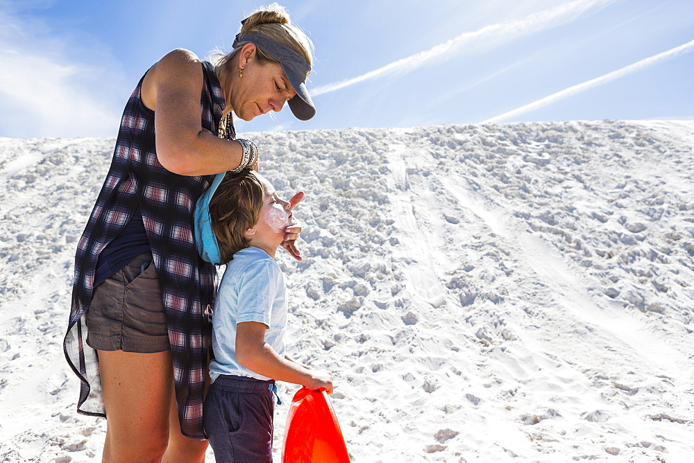 Mother applying sunblock to her child, White Sands National Monument, New Mexico, United States