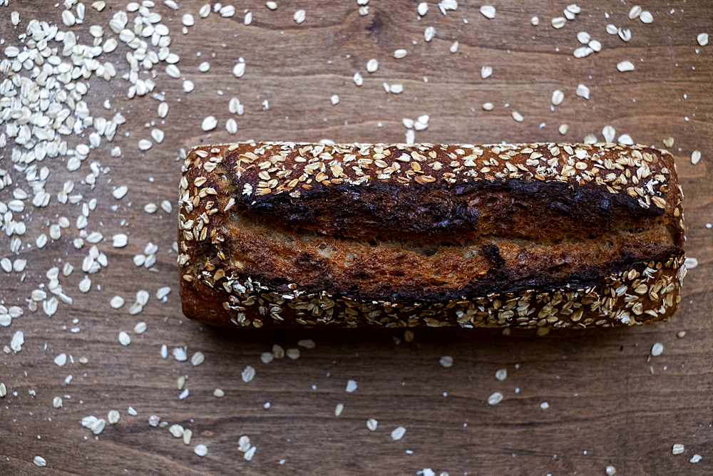 High angle close up of freshly baked seeded loaf of bread in an artisan bakery.