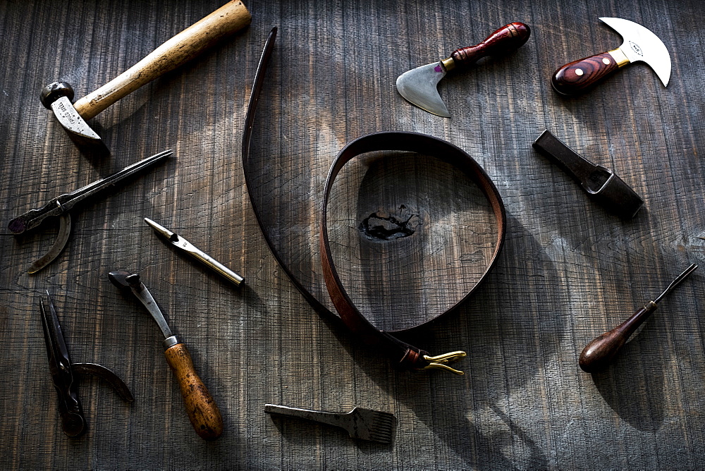 High angle close up of selection of saddle making hand tools, Berkshire, United Kingdom