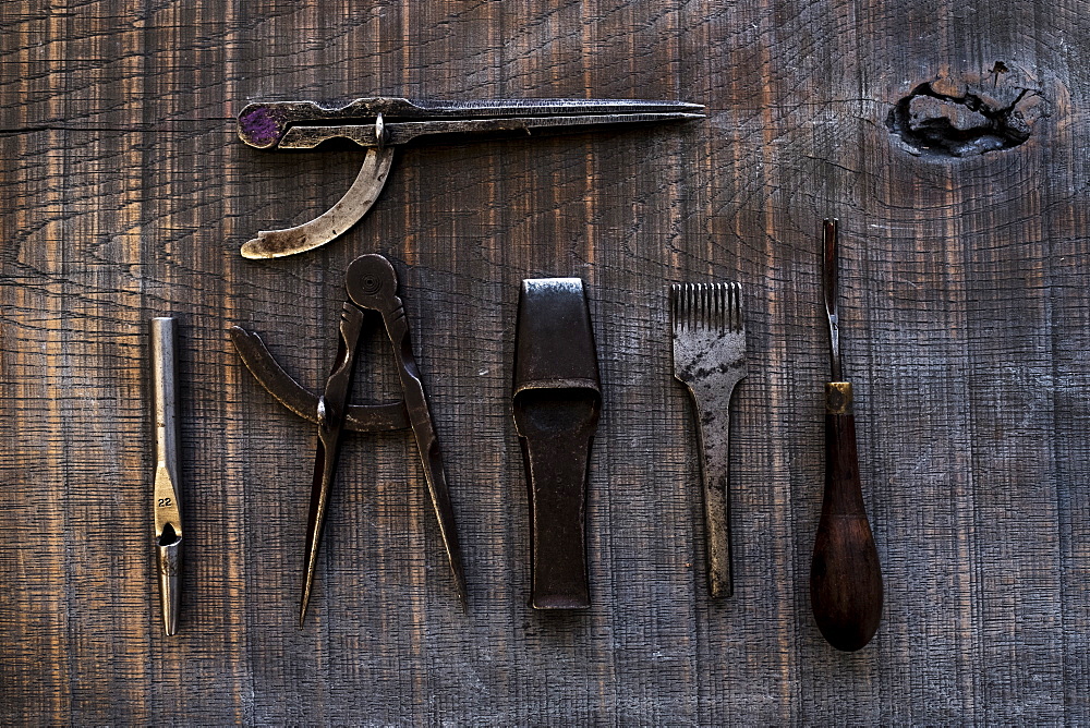 High angle close up of selection of saddle making hand tools, Berkshire, United Kingdom