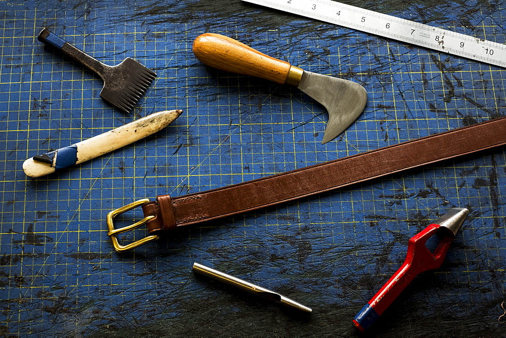 High angle close up of selection of saddle making hand tools, Berkshire, United Kingdom