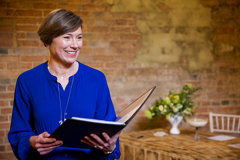 Celebrant performing naming ceremony in an historic barn