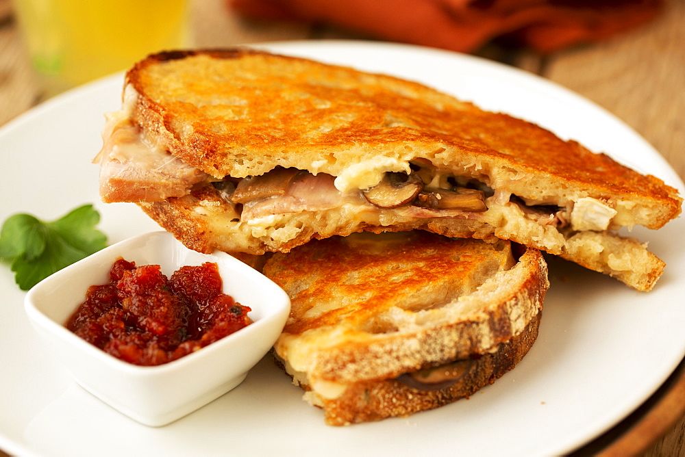 Close up of toasted sourdough mushroom melt with chutney in a cafe