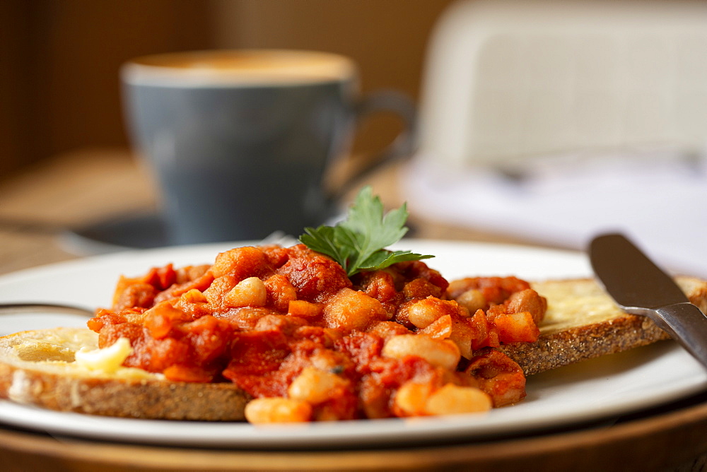 Close up of home made baked beans on sourdough bread in a cafe