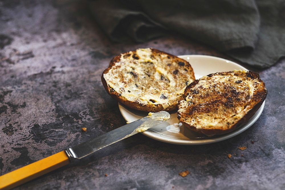 Artisan bakery, a toasted buttered teacake on a plate