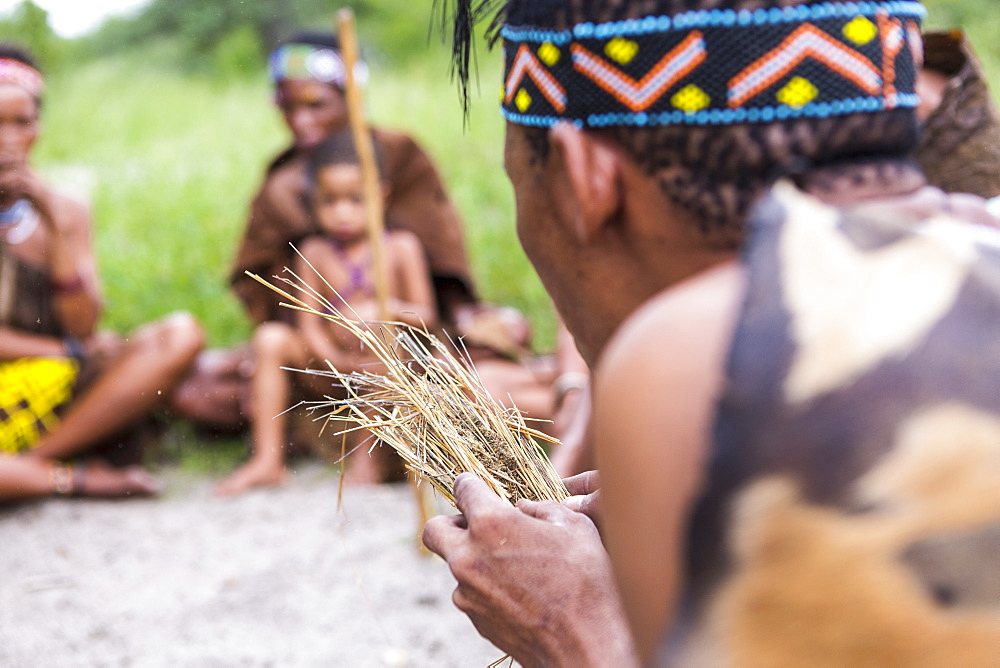 San People, a bushman creating fire from dry kindling, a cultural demonstration