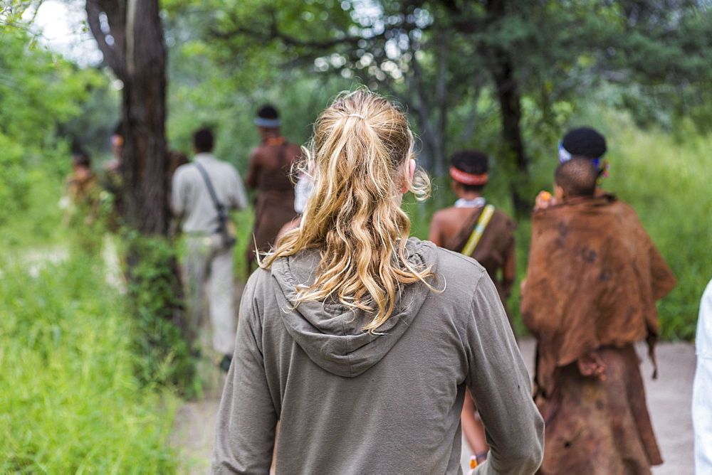 Tourists on a walking trail with members of the San people, bushmen in Botswana