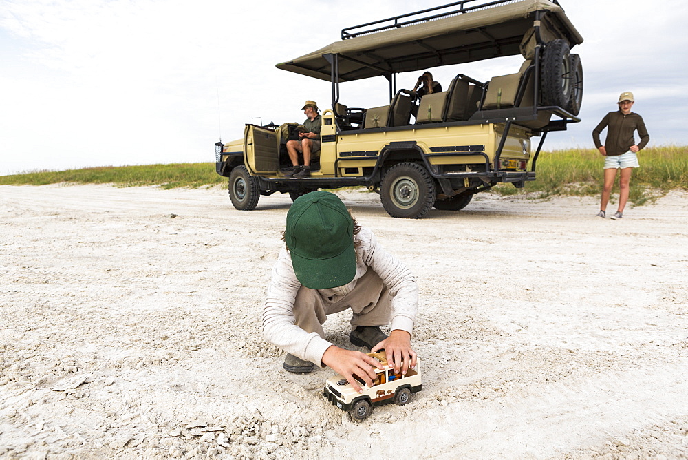 Six year old boy playing with toys, Nxai Pan, Botswana