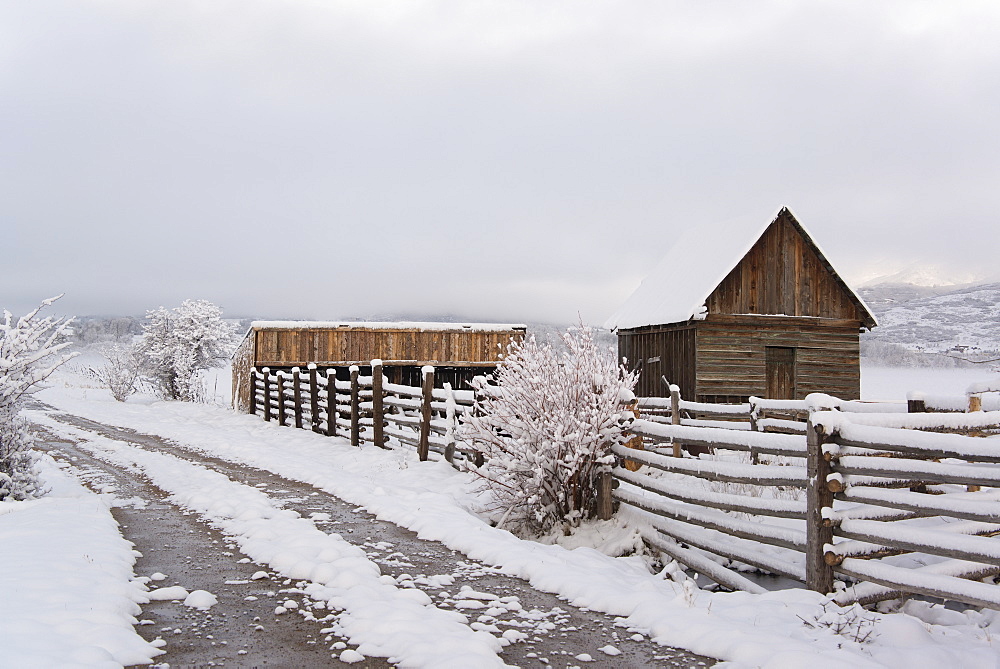 A barn and paddock with fencing in the snow in the Green River Lakes area, Green River Lakes, Wyoming, USA