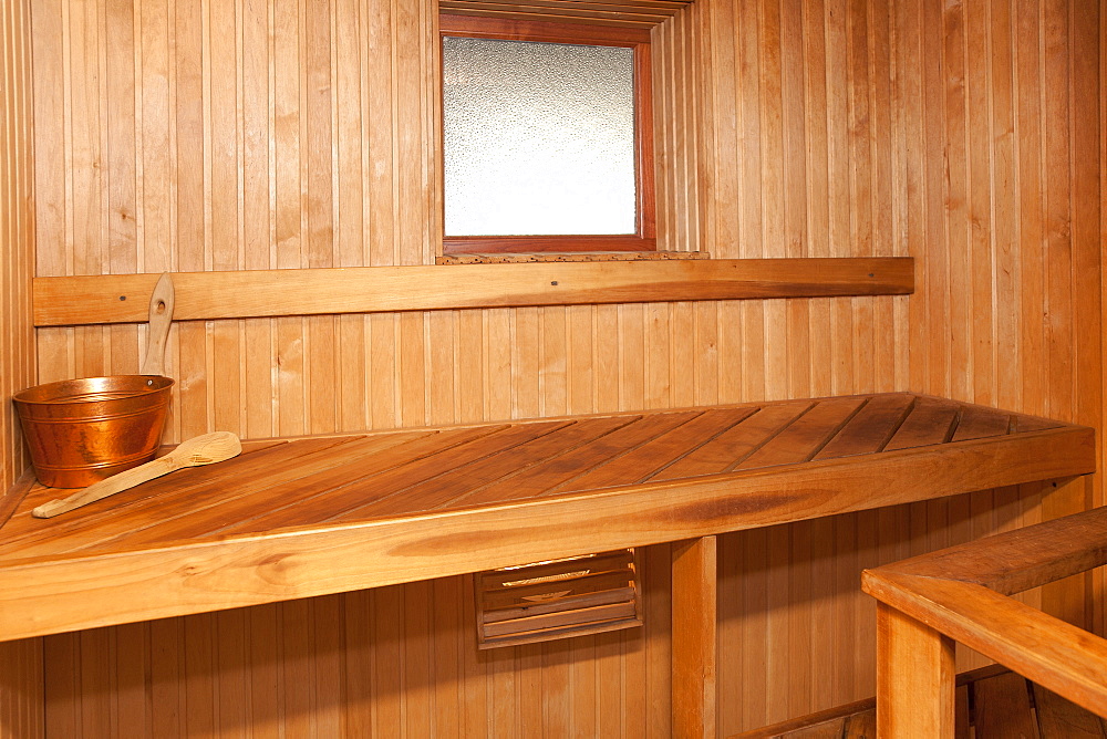 Empty Spa sauna interior, wooden clad walls and seating, Estonia