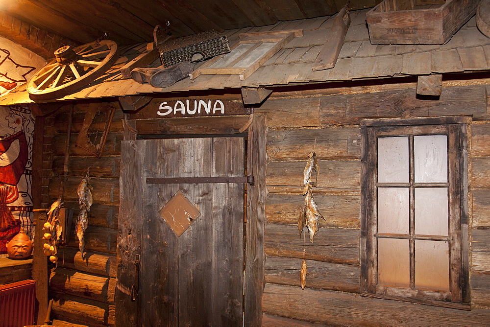 A hotel with old fashioned retro styled rooms and rustic objects, door to the sauna, Estonia