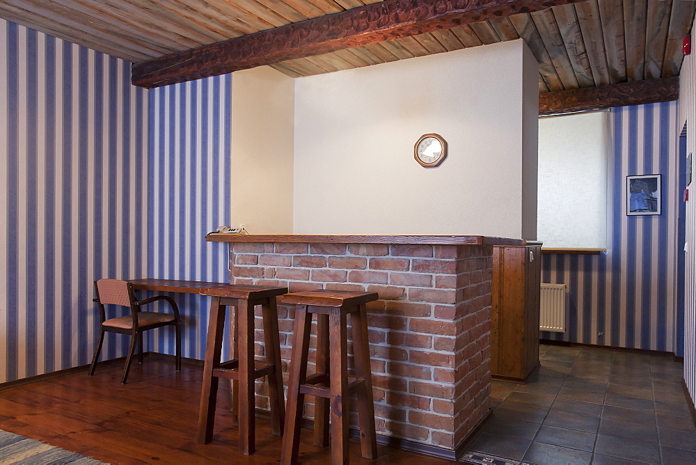 A hotel with old fashioned retro styled rooms, bar with two bar stools and striped wallpaper, Estonia