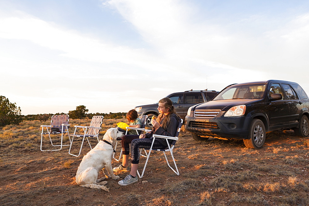 children sitting in lawn chairs eating dinner, Galisteo Basin