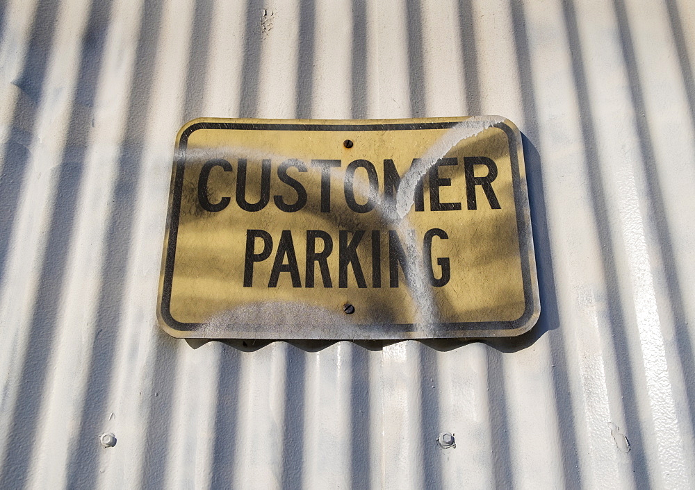 Customer Parking sign on warehouse exterior