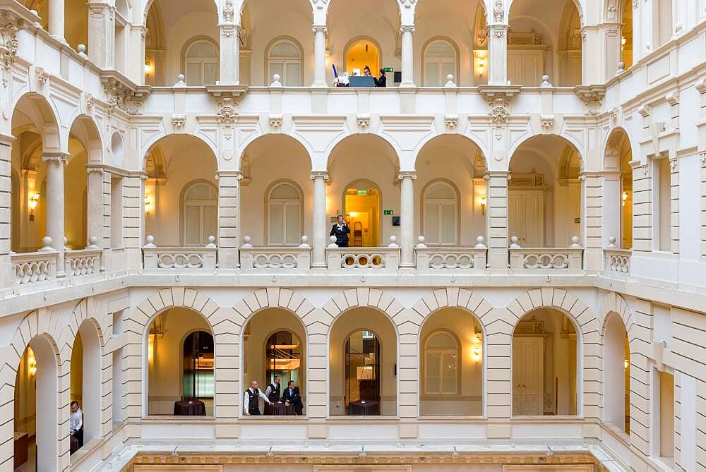 Hotel, a historic building with atrium and walkways, classical architecture, people on each level