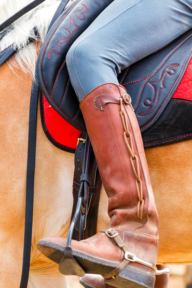 Horse rider with ornate leather riding boots, Tuscany Italy