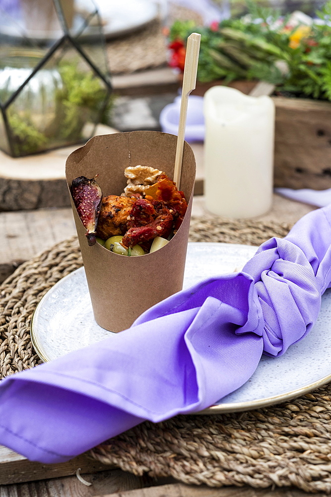 Rustic style place setting and food for a woodland naming ceremony