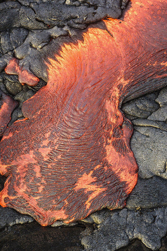 Lava flow over volcanic black rock.