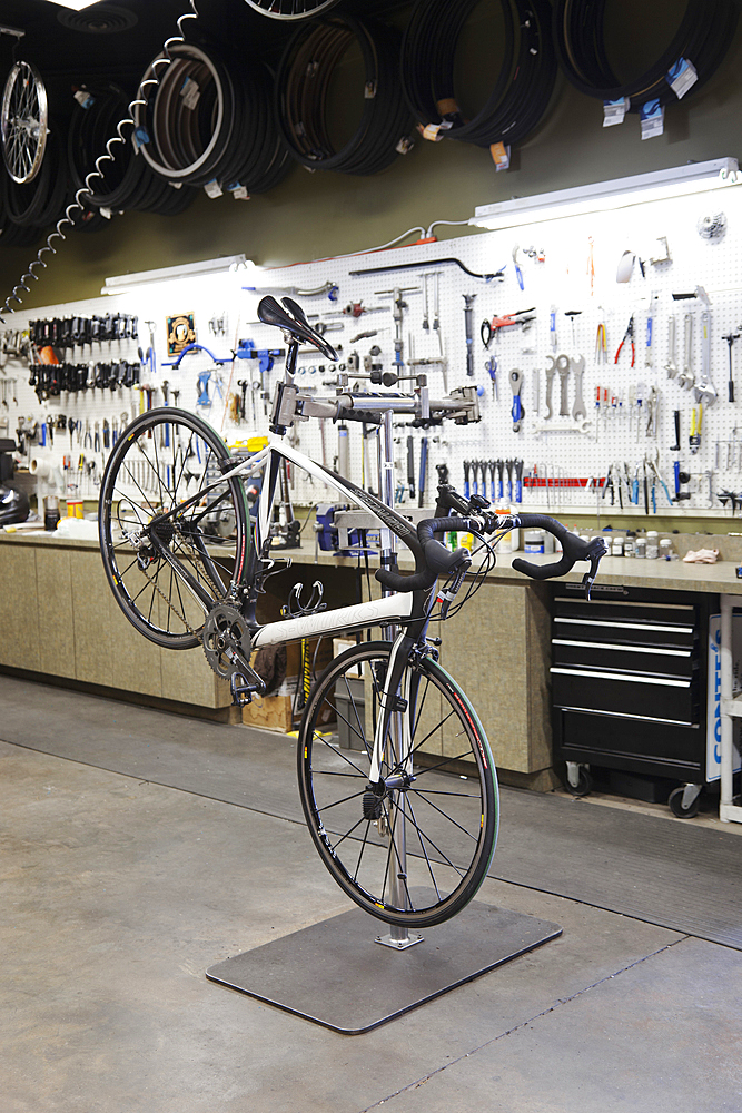 Cycle repair shop interior, tool boards and tools at a service counter.