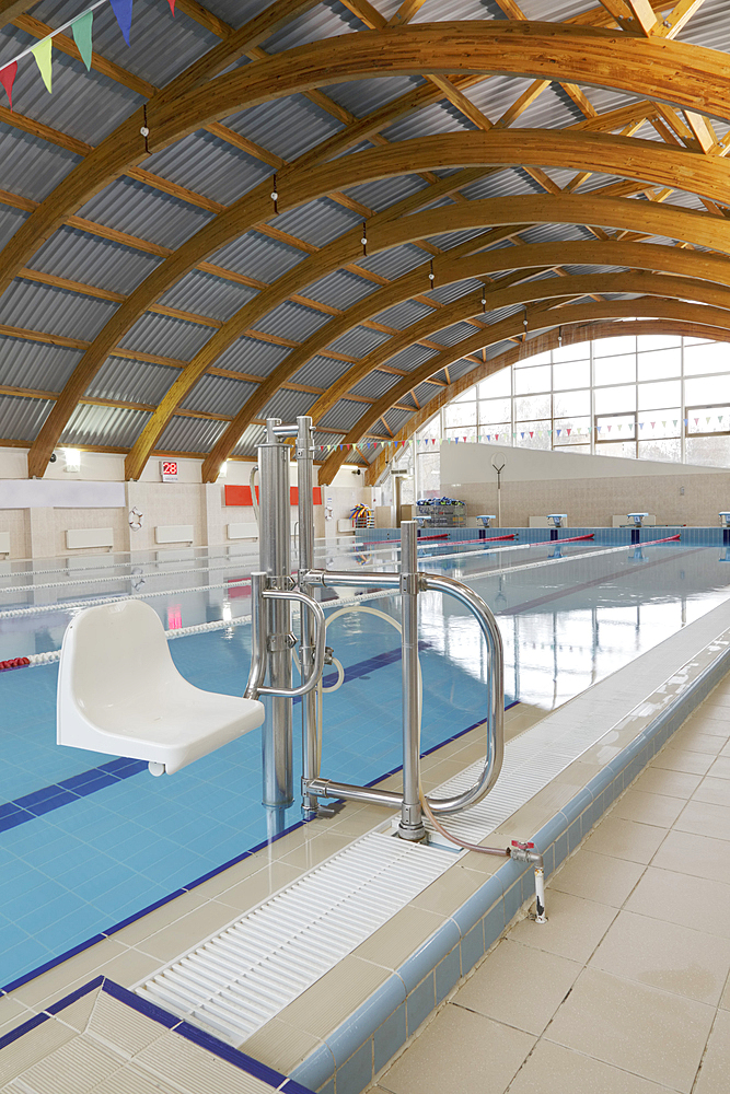 Indoor swimming pool, a chair and hoist for disabled people.