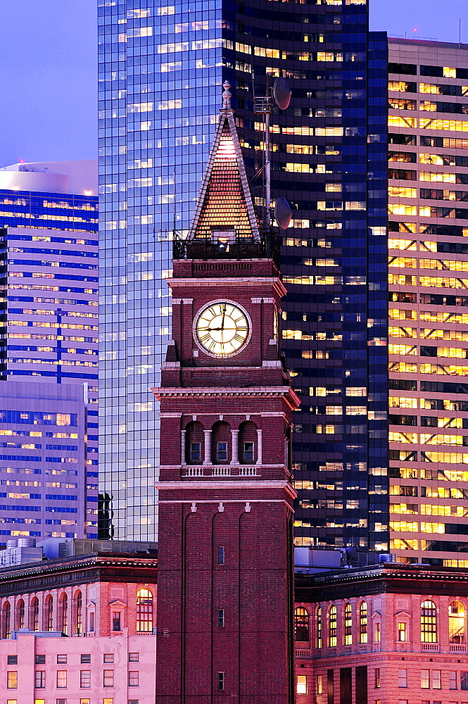 King street station clock, among tall skyscrapers in Seattle at dusk, Seattle, United States