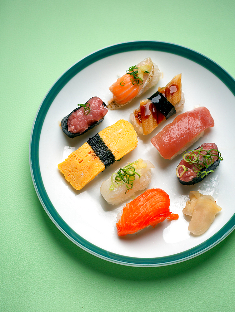 Sushi platter, a selection of raw fish and rice snacks with chopsticks.