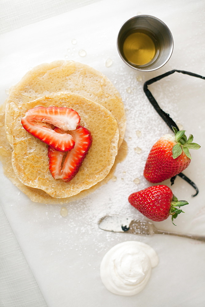 A selection of party desserts. Pancakes, freshly cooked, with strawberries and a drink. Organic food, Park City, Utah, USA