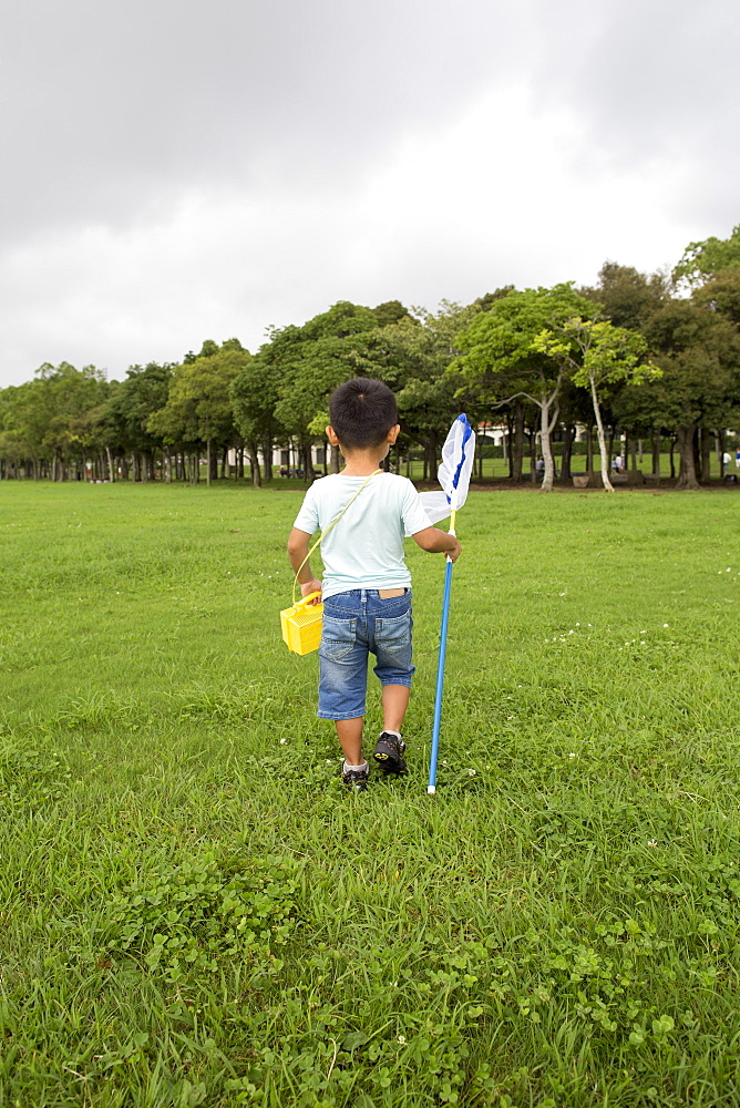 Young boy carrying a butterfly net, Kyoto, Honshu Island, Japan