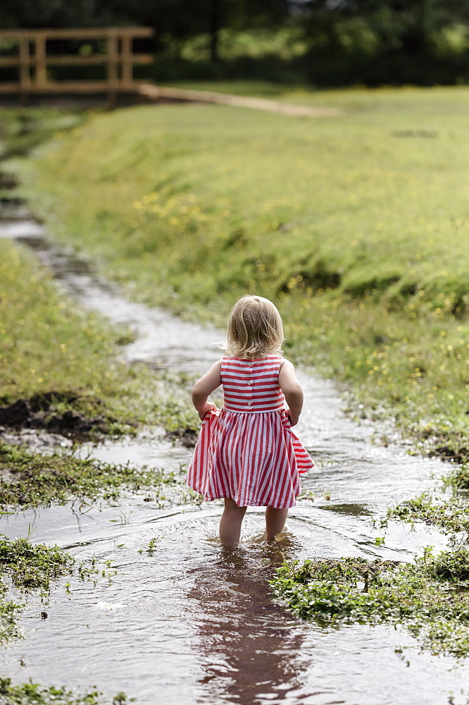 A young girl playing outdoors, Hampshire, England