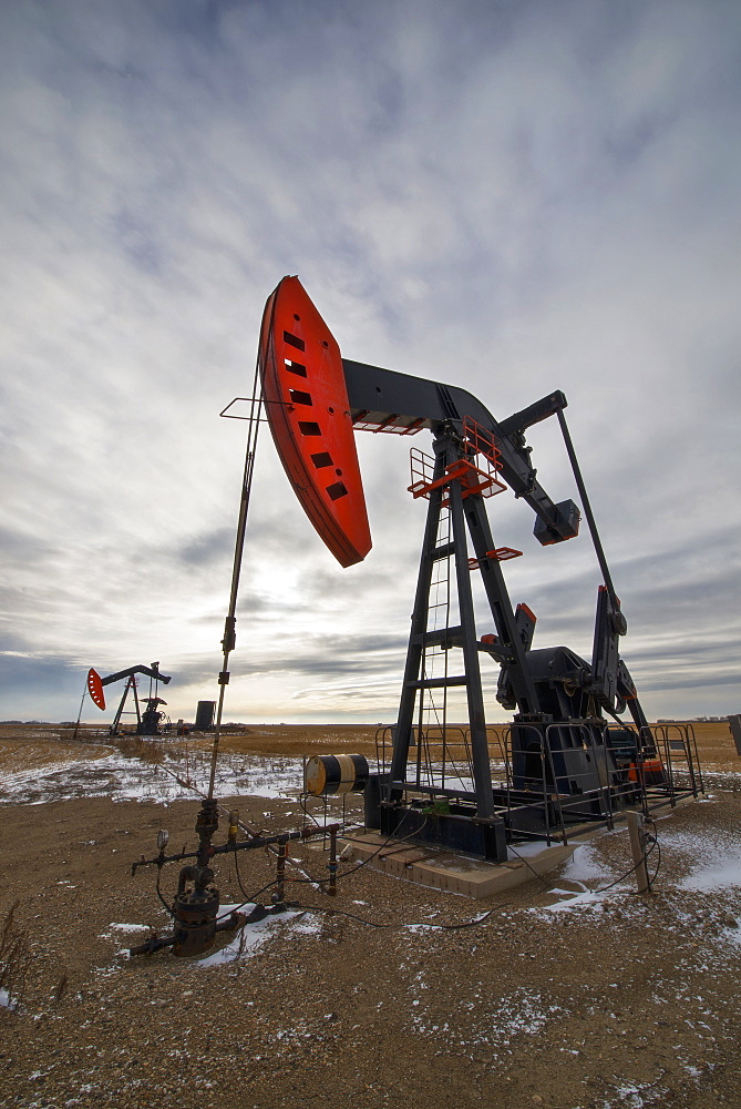 An oil pump jack at a drilling site for oil, an oil field in SaskatchewanOil field pump jack, Saskatchewan, Canada