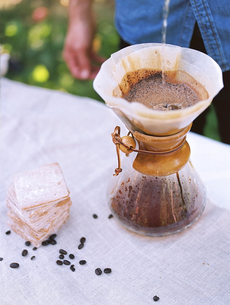 An apple orchard in Utah. man standing at a table, making coffee, Sataquin, Utah, United States of America