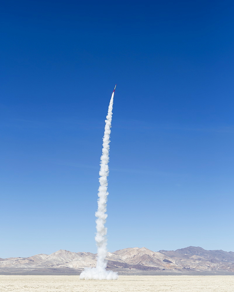 Rocket shooting into vast, desert sky, Black Rock Desert, Nevada, United States of America