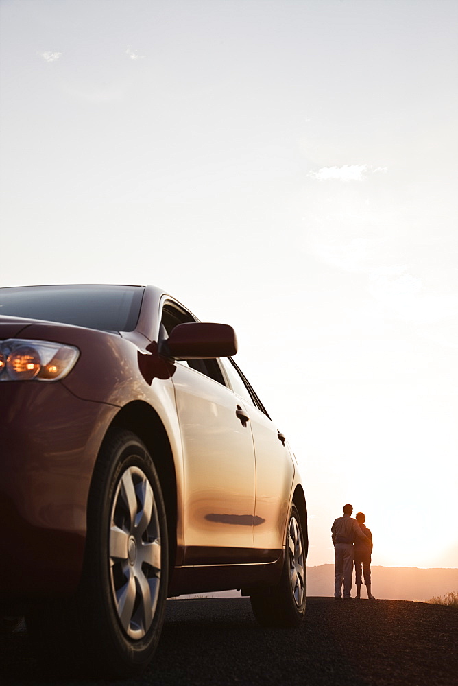 Senior couple watching a sunset from a rest stop on a road trip in eastern Washington State, United States of America