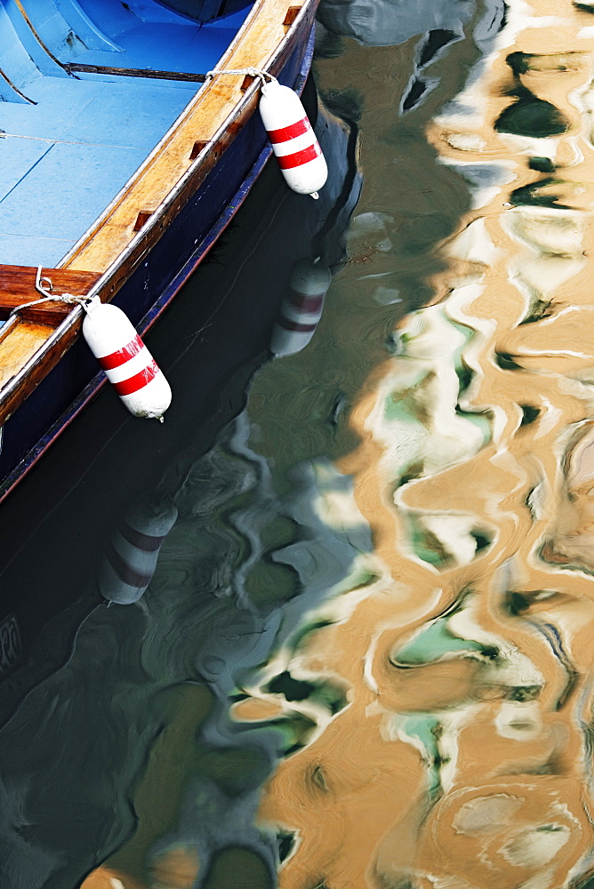 Sunlight and Boat Reflected in Canal, Venice, Italy