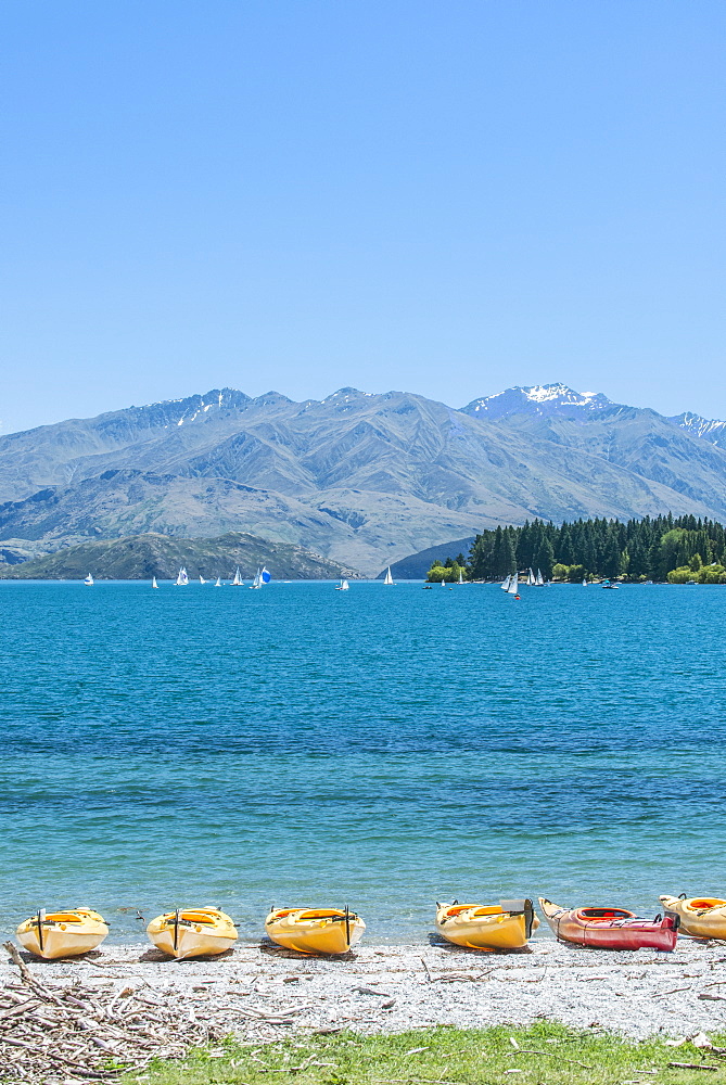 Kayaks docked along beach, Lake Wanaka, Otago, New Zealand, Lake Wanaka, Otago, New Zealand