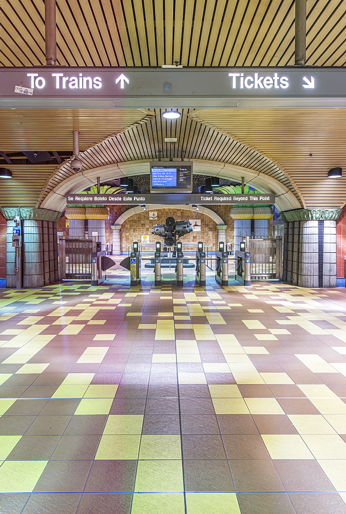 Turnstiles and signs in subway station